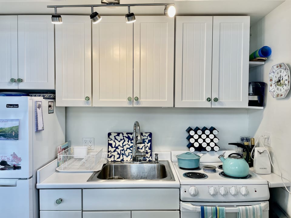 Detail of Kitchen which is fully equipped. Island in front of it has microwave