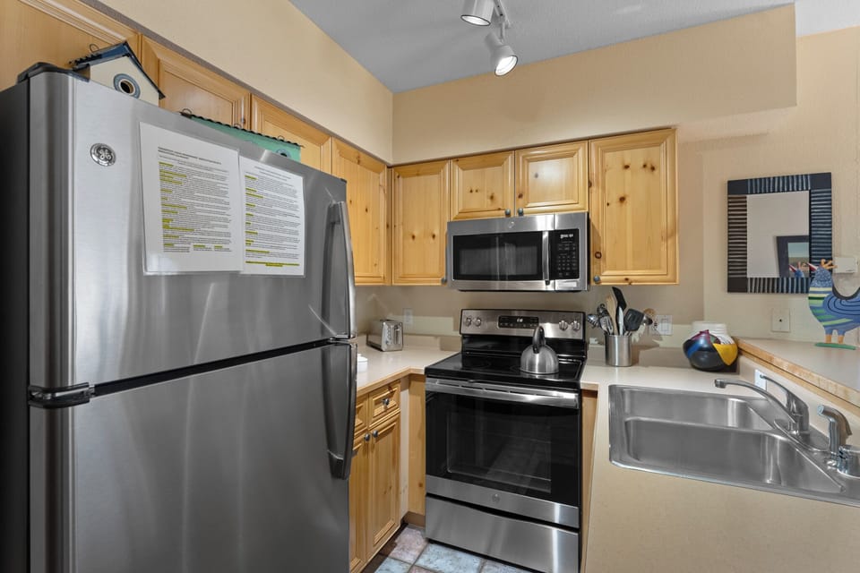 Your fully equipped kitchen invites you to whip up delicious meals with stainless steel appliances and warm wood cabinetry.