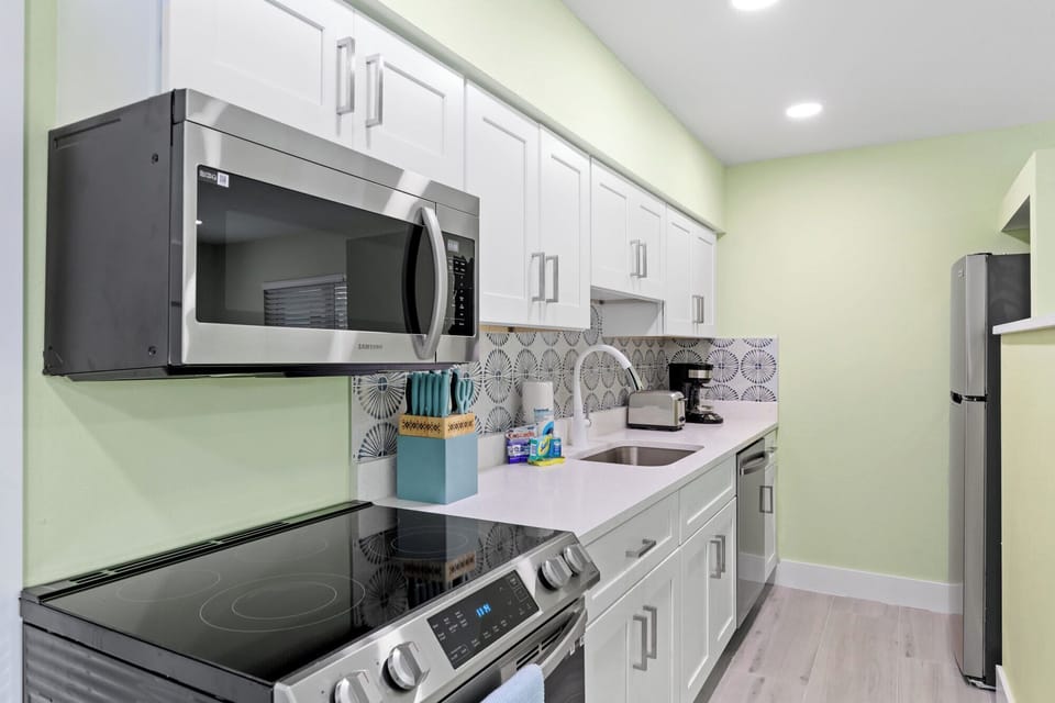 Pirates Cove cottage features an expansive living room with Braxton Culler memory foam sleeper sofa, full kitchen, bedroom with king bed, and bathroom with walk in shower