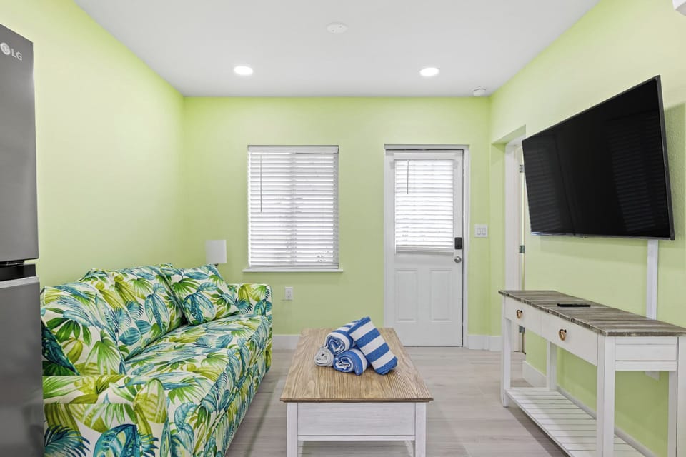 Living room features a queen sleeper sofa and flat screen TV