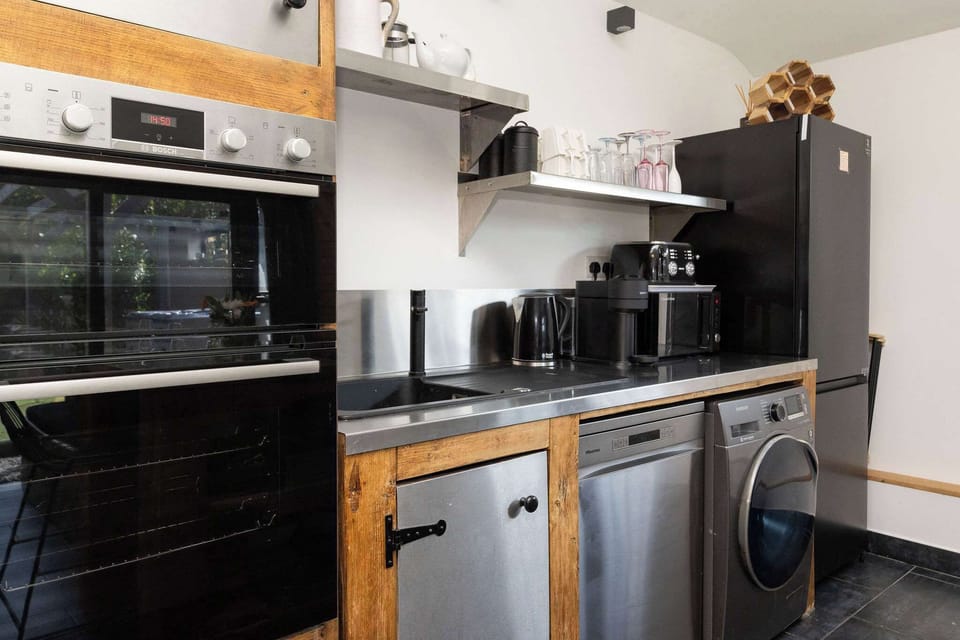 This contemporary kitchen setup boasts high-end appliances perfect for a premium holiday rental experience.