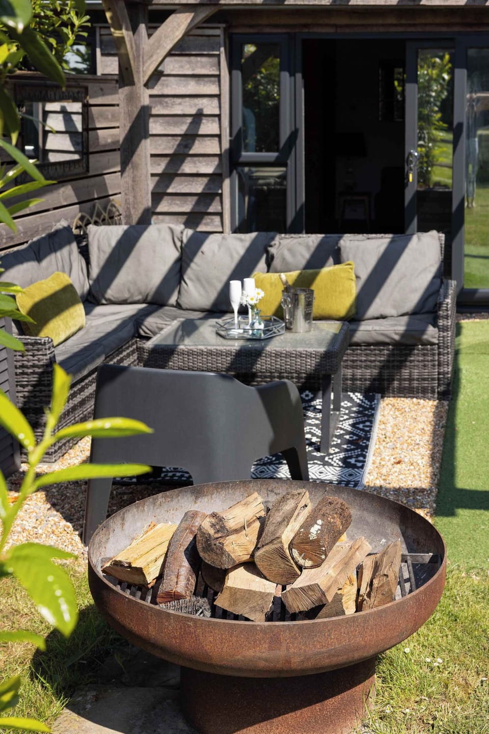 Gather around the fire pit for relaxing evenings in this comfortable outdoor lounge area.