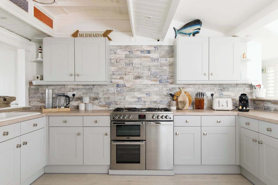 There is a Nespresso coffee machine, kettle, toaster, double oven, dishwasher and hob.