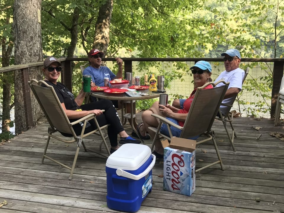 Guests enjoying a lunch and beer on the observation deck above the River Dock