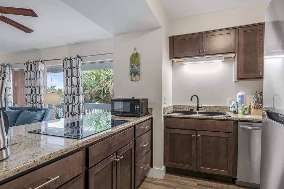 We've stocked this kitchen with a refrigerator, dishwasher, electric stovetop, and a large toaster oven.