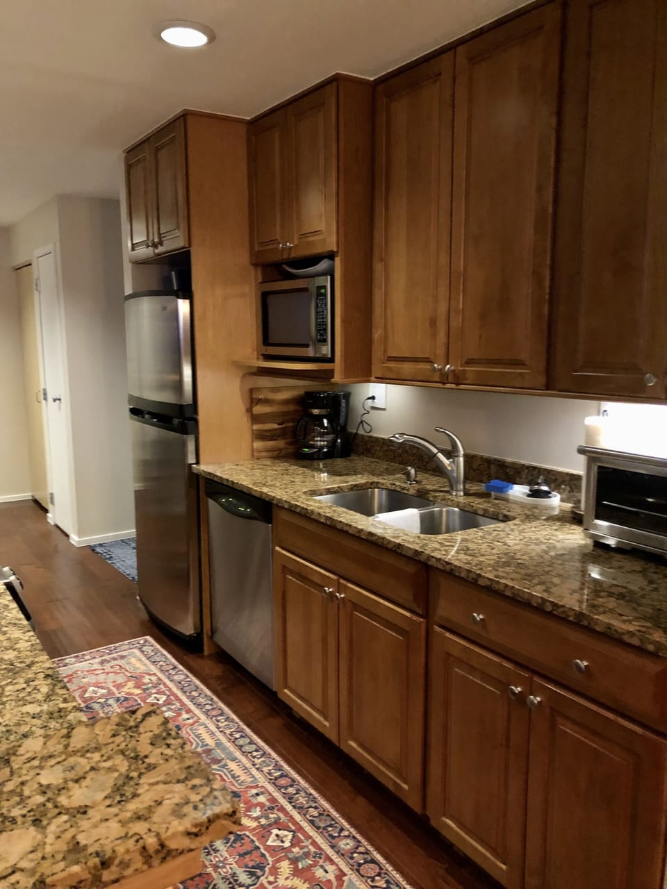 Kitchen has coffee-maker, tea kettle, countertop oven, blender, etc. 