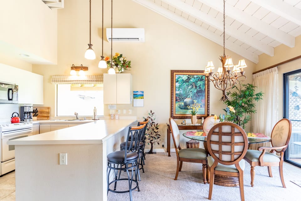 Step into your airy, open-concept kitchen and dining area, where vaulted ceilings and warm natural light create the perfect setting for memorable meals and laughter with loved ones.