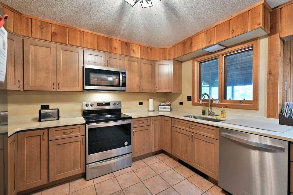 Virginia Beach #6's modern full kitchen with updated appliances and wooden cabinetry.