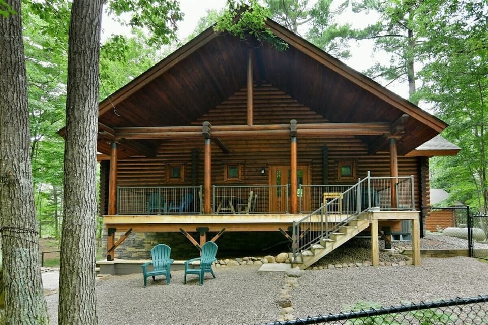 The back deck leading down to a fenced back yard.