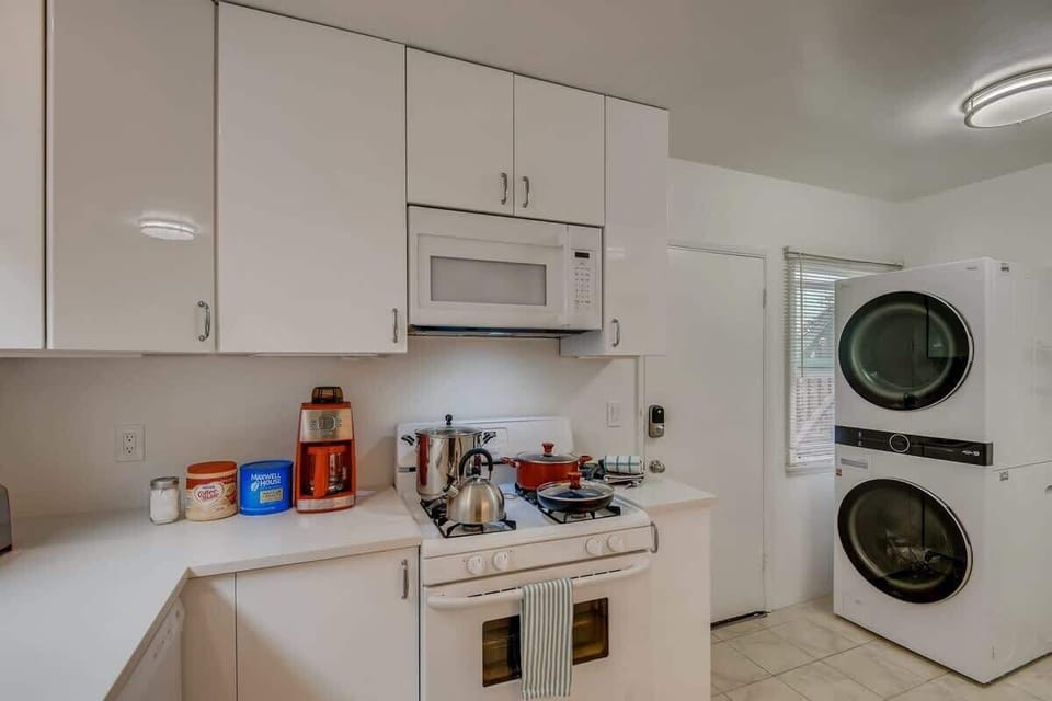 Enjoy the newly remodeled kitchen with private in unit LG washer/dryer, refrigerator, oven, stove, microwave, dishwasher, coffee, creamers, mixers, spices, pots, pans, cooking supplies, cutlery, cups, plates, bowls, utensils, small appliances, and many essentials.