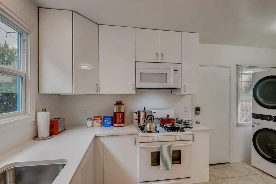 Enjoy the newly remodeled kitchen with private in unit LG washer/dryer, refrigerator, oven, stove, microwave, dishwasher, coffee, creamers, mixers, spices, pots, pans, cooking supplies, cutlery, cups, plates, bowls, utensils, small appliances, and many essentials.