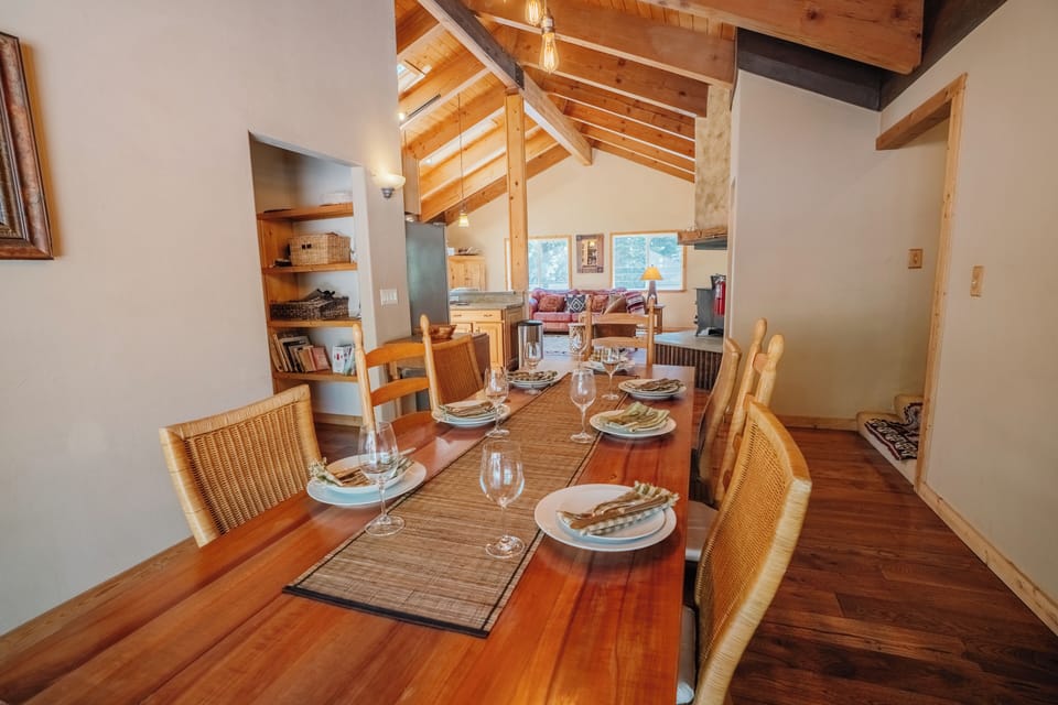 This large dining setup features a table, making it ideal for everything from casual breakfasts to formal dinners