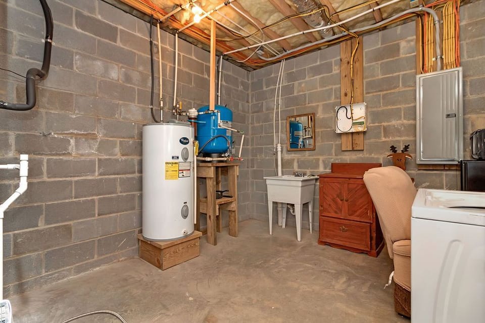 Dehumidifier, sink, hot water heater and storage downstairs/basement