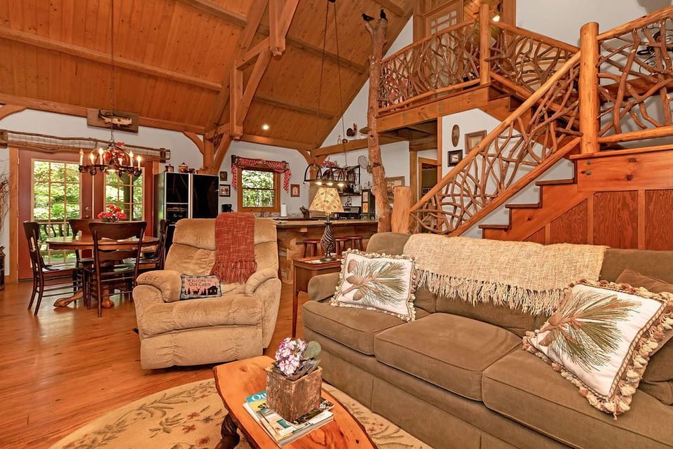 In the living room near the fireplace, you can see the dining/kitchen/upstairs