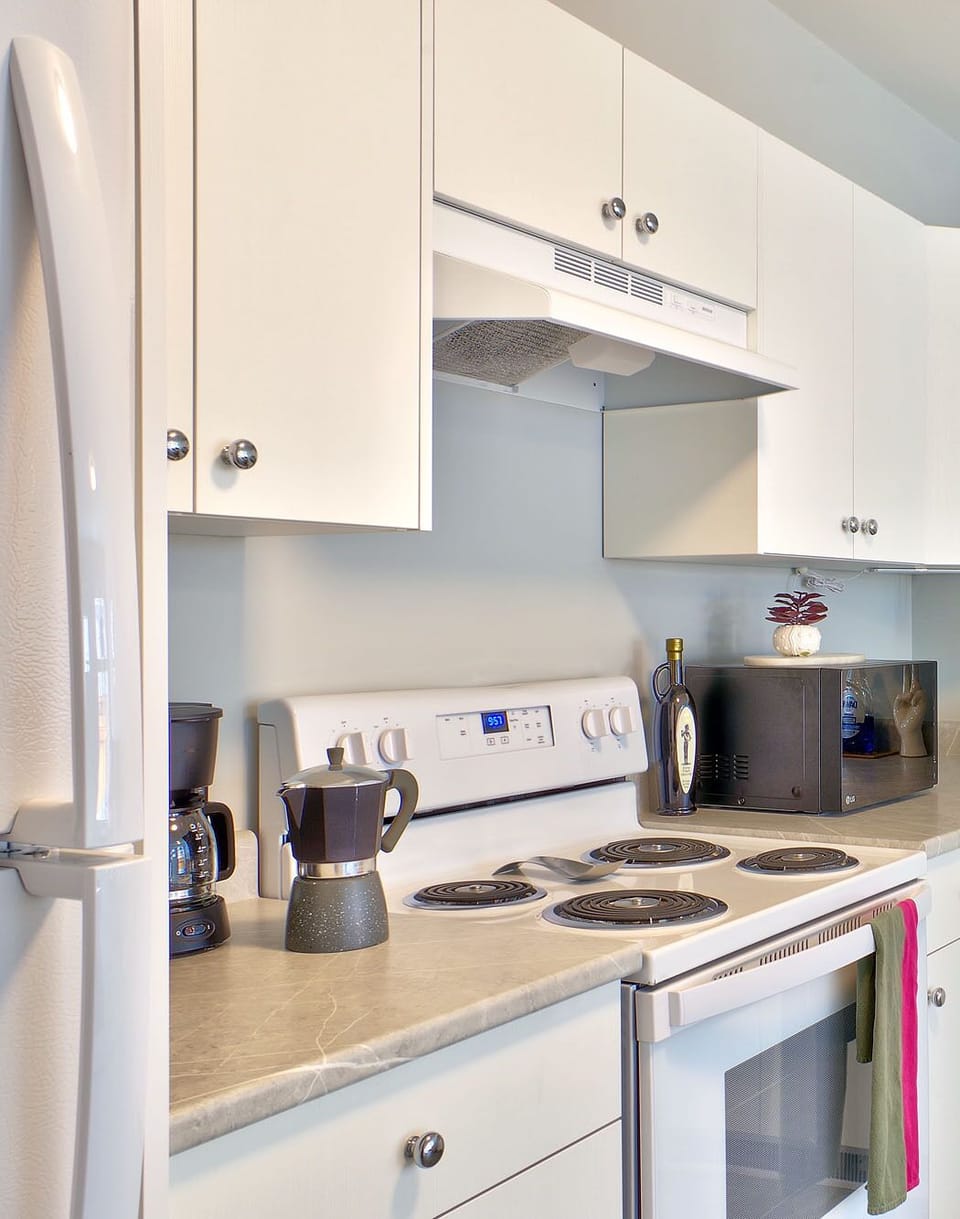 Microwave, pots & pans, Tupperware, kids' plates, high chair, extra chairs.