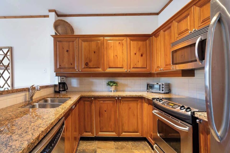- Fully equipped wooden kitchen with stainless steel appliances  
- Granite countertops and cookware ready for hearty meals after skiing  
- Modern design meets rustic warmth for a true mountain stay  
