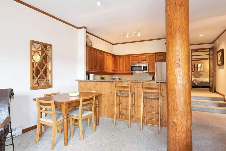 - Bright open-concept kitchen and dining with rustic wood accents  
- Granite breakfast bar and seating for casual mountain dining  
- Steps away from cozy living space and alpine views  
