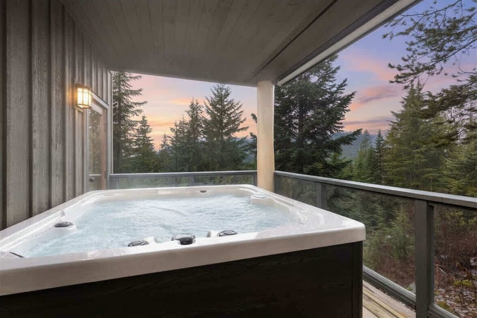 - Private outdoor hot tub with panoramic forest mountain views - Perfect spot for relaxing après-ski soak in crisp alpine air - Covered balcony ensures comfort in every season