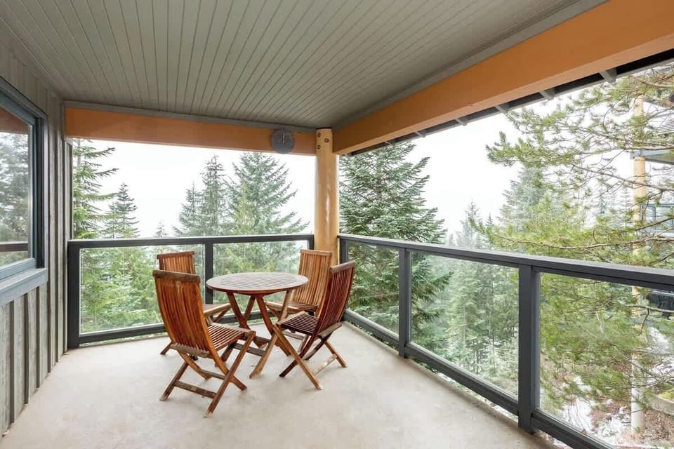 - Covered balcony with forest and mountain scenery all around  
- Wooden seating for peaceful morning coffee or evening wine  
- Fresh alpine air makes every moment feel rejuvenating  
