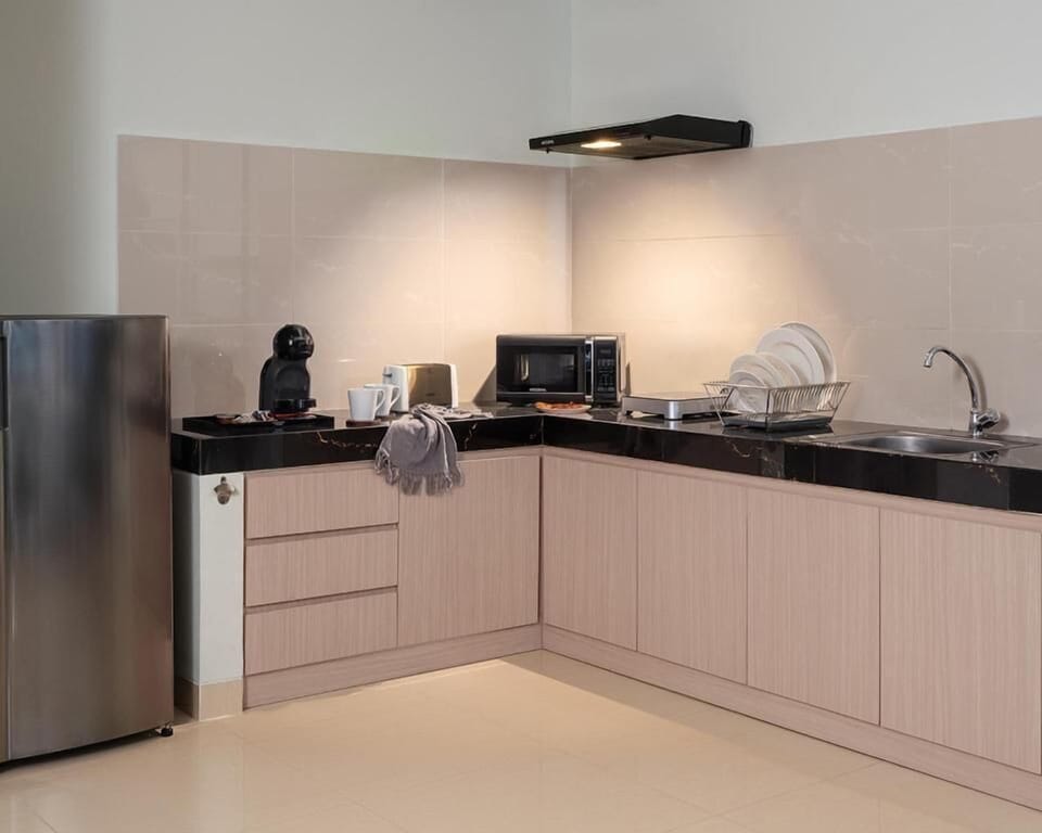 Coffee/tea maker, fridge, microwave, dining table
