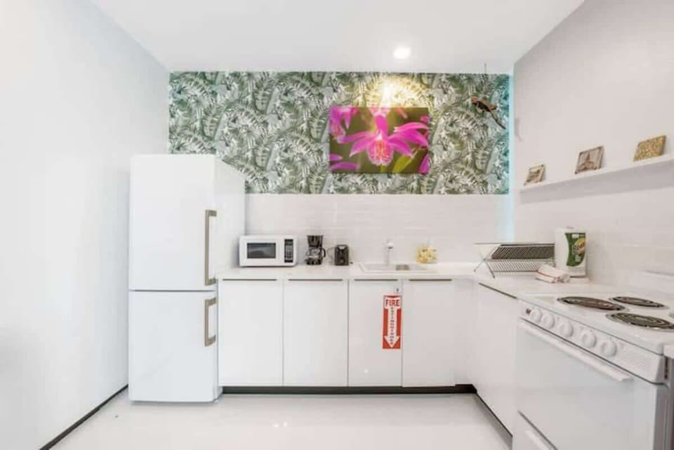 The kitchen is stocked with a full set of appliances including basic kitchen utensils. 