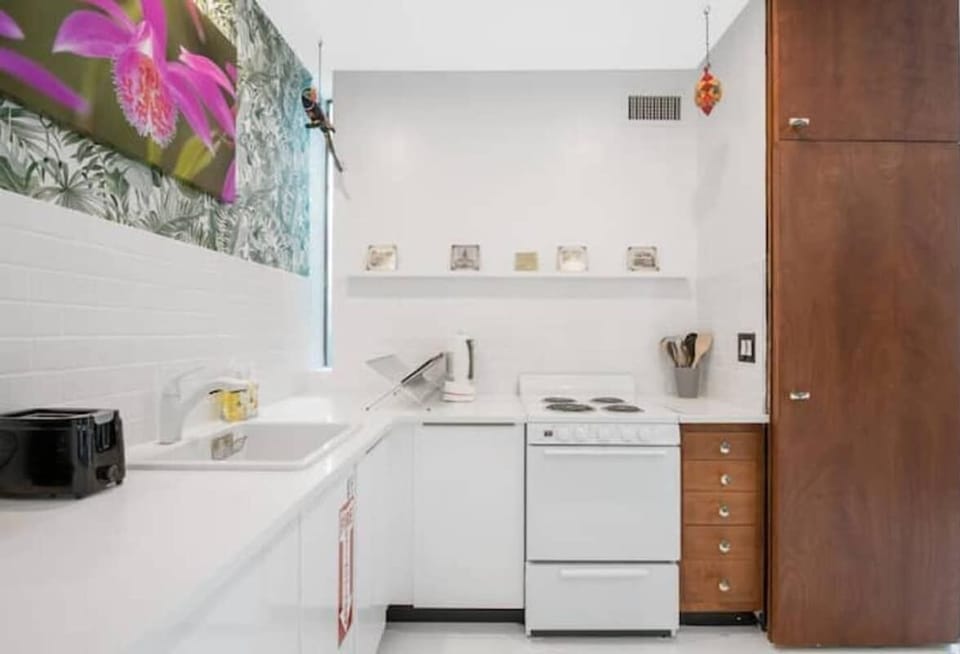 The kitchen is stocked with a full set of appliances including basic kitchen utensils. 