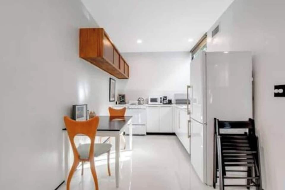The kitchen is stocked with a full set of appliances including a basic kitchen utensils. 