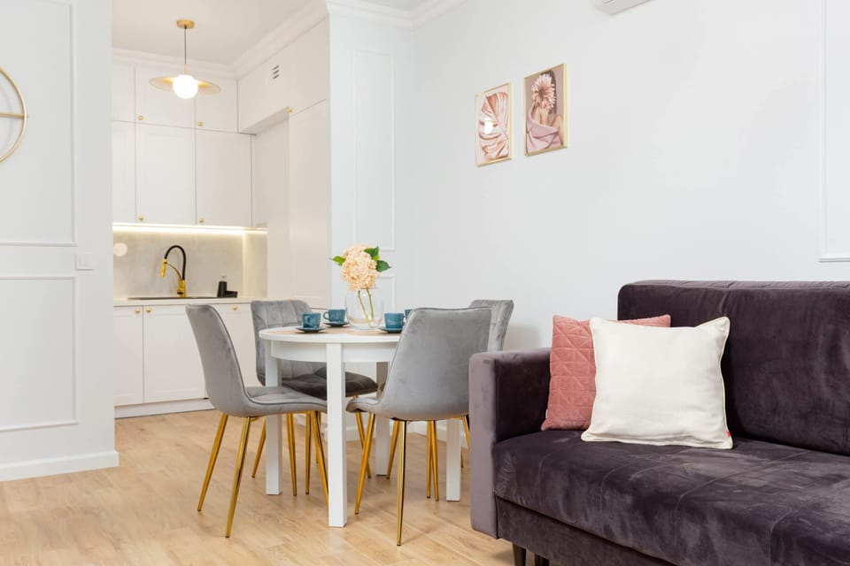 A comfortable dining area with a modern table, gray chairs.
