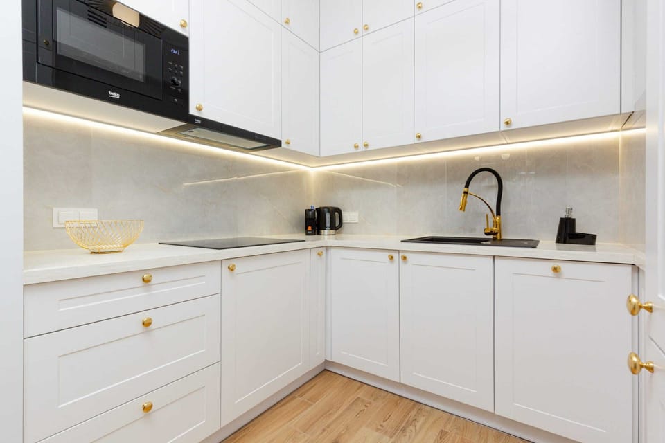 A spacious and bright kitchen corner with a functional layout and contemporary design.
