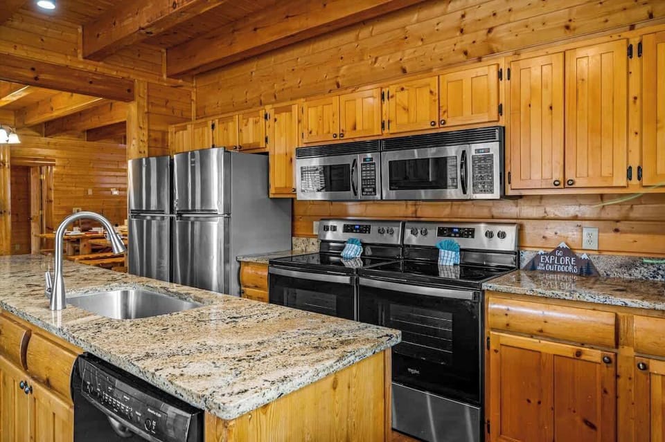 Modern kitchen equipped with (2) fridges, (2) cooktop stoves, (2) dishwashers, (2) microwaves, and brand new granite countertops. The kitchen is equipped with plenty of kitchenware and everything needed for large groups or family gatherings.