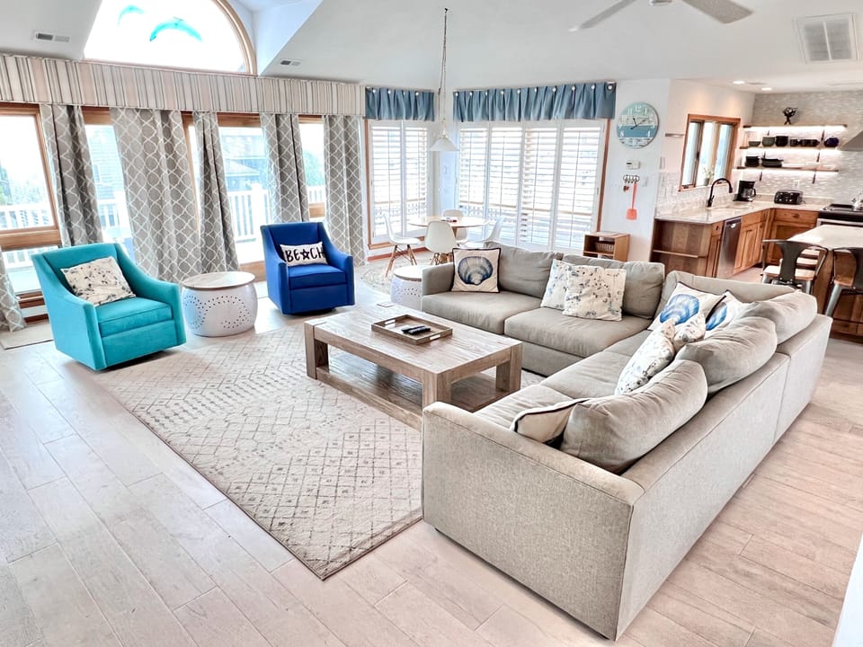 Living Room - Located on the top floor of this home, the open concept, high ceilings and coastal colors welcome you to this oceanfront beauty.