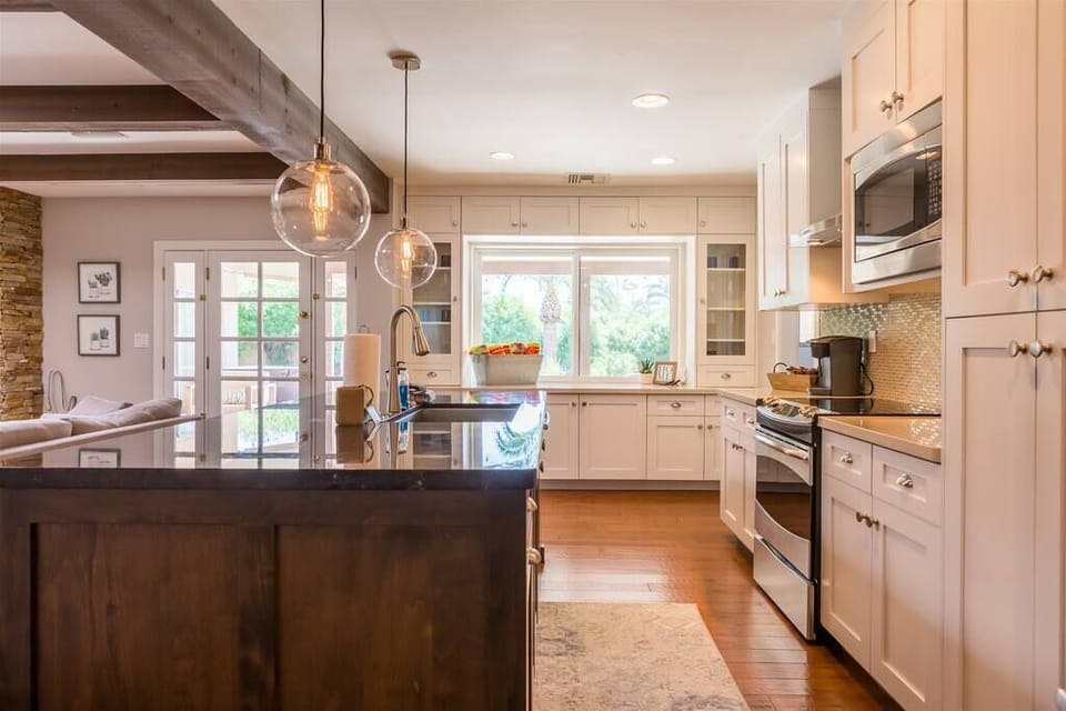 Fully stocked kitchen with stainless appliances and granite counters