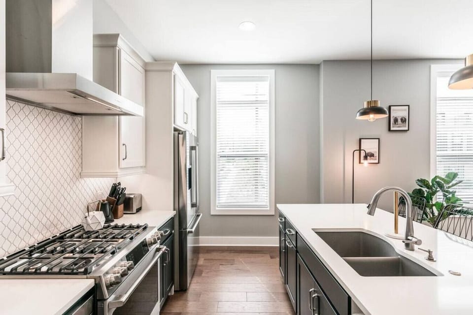 Amenities include gas range, side by side sink, & dishwasher.