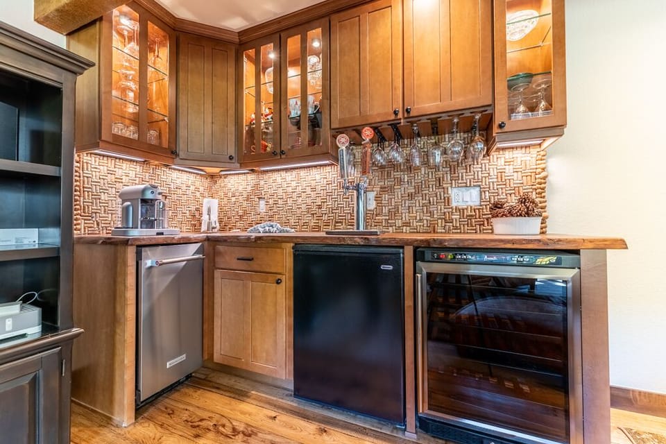 Your gourmet kitchen features rich wood cabinetry, elegant tile backsplash, premium appliances, and sophisticated lighting for memorable culinary experiences.