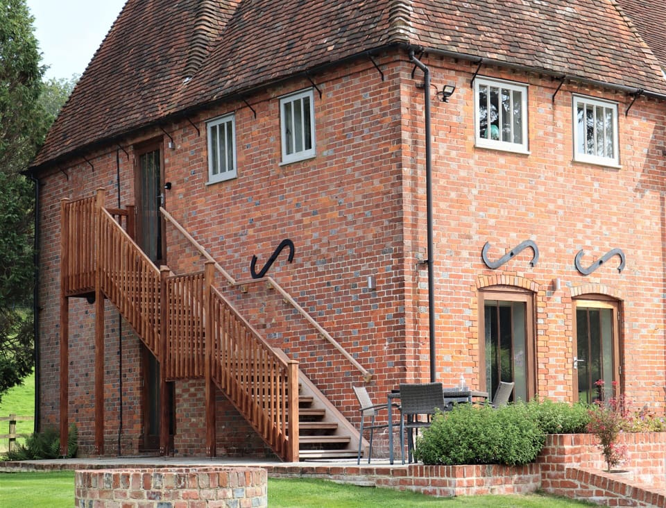 Exterior staircase leading up to to the cottage with outside tables & chairs