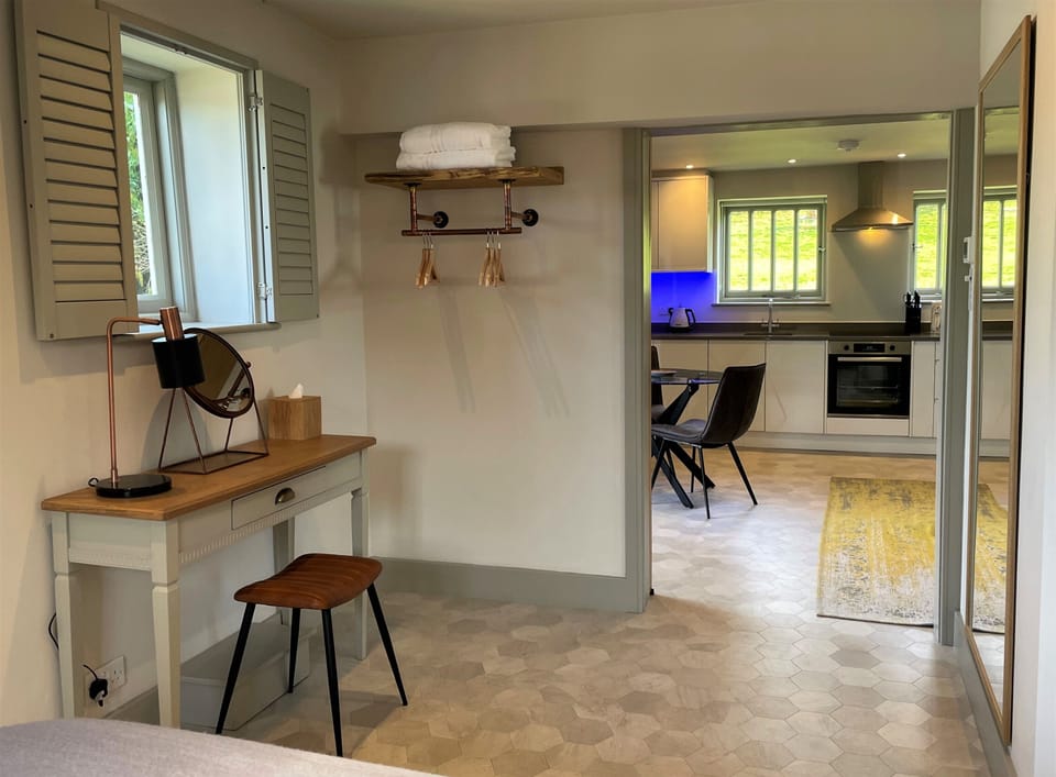 Looking from the bedroom into the open plan lounge, dining area and kitchen.