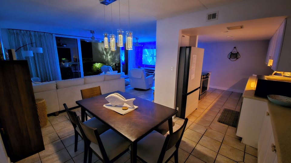 indoor, kitchen, oven, couch living area, television, stovetop, dining table