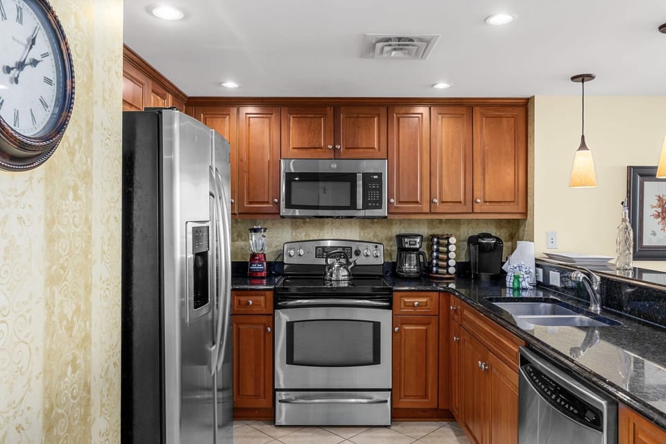 Modern kitchen with stainless steel appliances and warm wood cabinetry