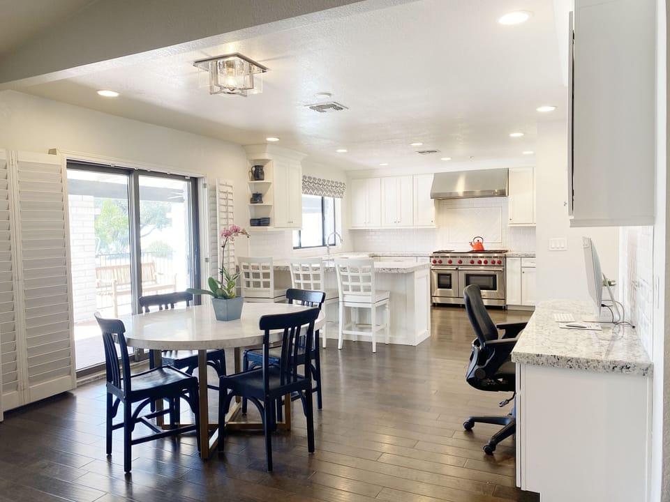 Informal dining/game table plus business center next to the kitchen. 