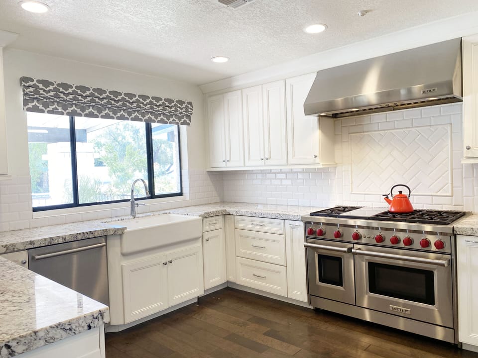 Kitchen with Dual Wolf Oven Stove with Griddle. 