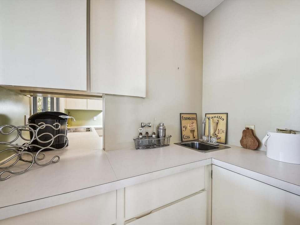 Wet Bar with Sink and Pass Thru Window to Kitchen at 63 Mooring Buoy