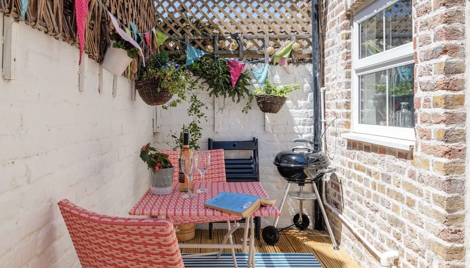 Sunny courtyard garden with Weber BBQ