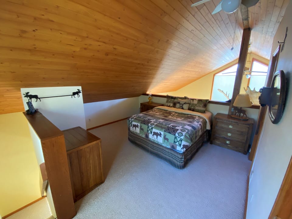 Upstairs loft bedroom with queen bed and master bath.