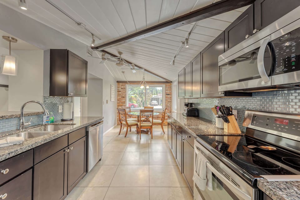 MAIN HOUSE KITCHEN #1- Dining Table/Breakfast Nook for 6.  There is also another dining table in the dining room.  Fully Appointed Updated Kitchen with Stainless Steal Appliances (Microwave, Refrigerator, Ceramic Cooktop & Oven, Dishwasher, Toaster, 
