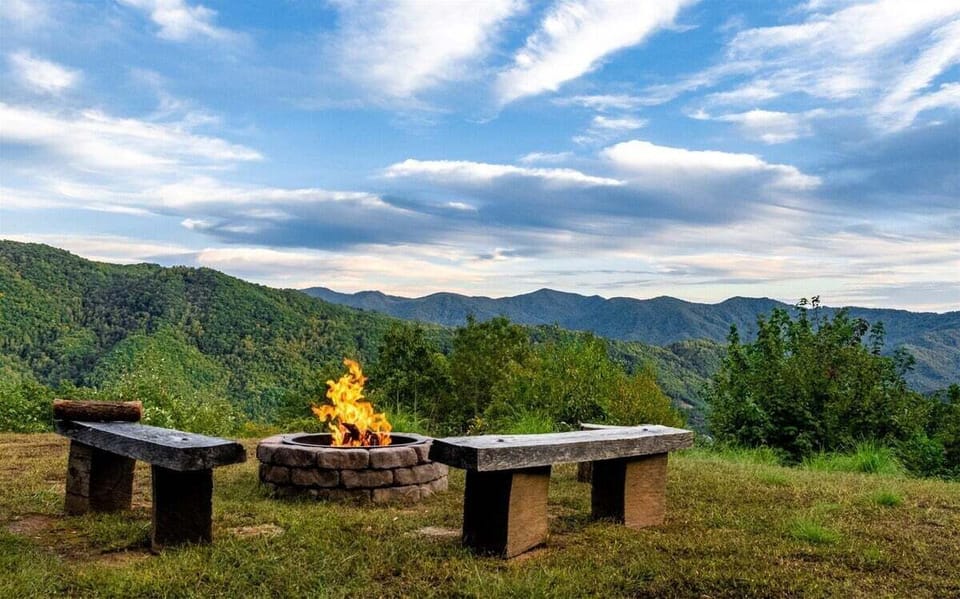 Fire pit area at A Walk in the Clouds overlooking Bryson City mountain views. Located near Great Smoky Mountains National Park, offering outdoor space for relaxing evenings at elevation.