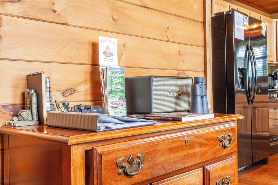Interior entry area at A Walk in the Clouds featuring wood console table and decor in Bryson City. Located near Great Smoky Mountains National Park with cabin-style interior finishes.