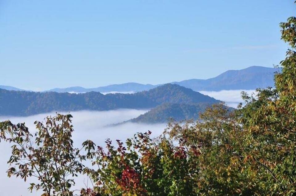 Elevated view of mountain ridges and Fontana Lake from A Walk in the Clouds in Bryson City. Convenient to Great Smoky Mountains National Park and surrounding outdoor destinations.