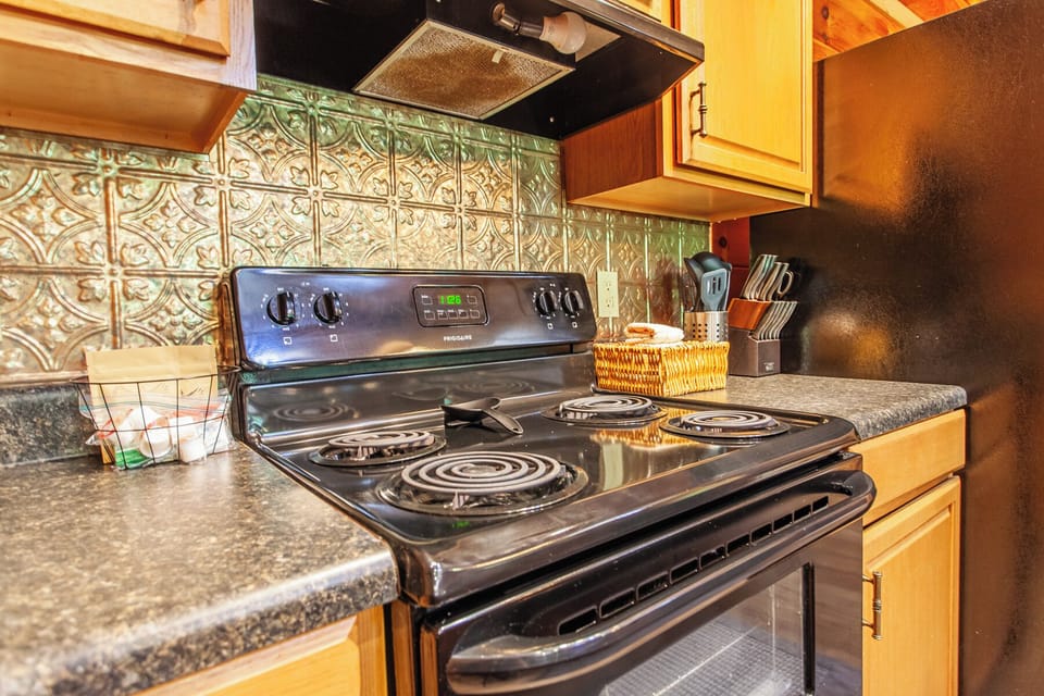 Full kitchen at Edgeview Chalet in Bryson City featuring a stove and oven for home-style meals.