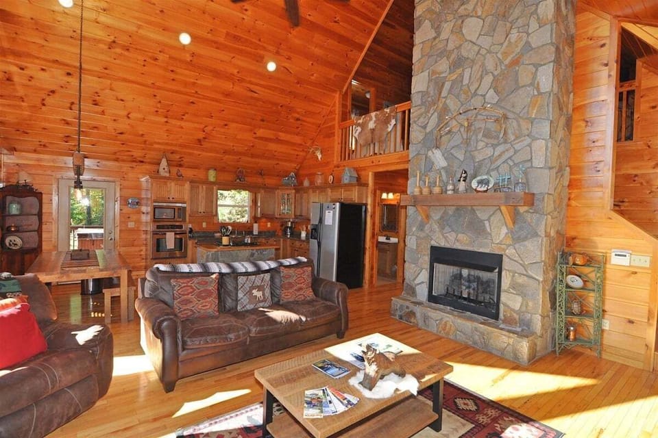 Cozy fireplace and TV setup in the den at A Sunrise in the Smokies cabin in Baines Mountain