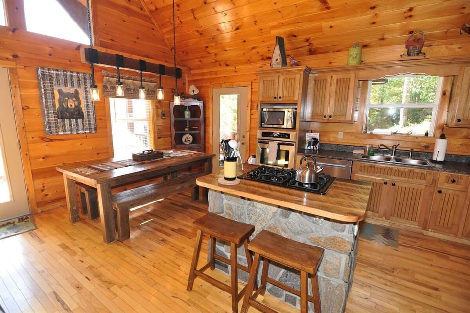 Rustic dining table next to kitchen at A Sunrise in the Smokies cabin in Baines Mountain